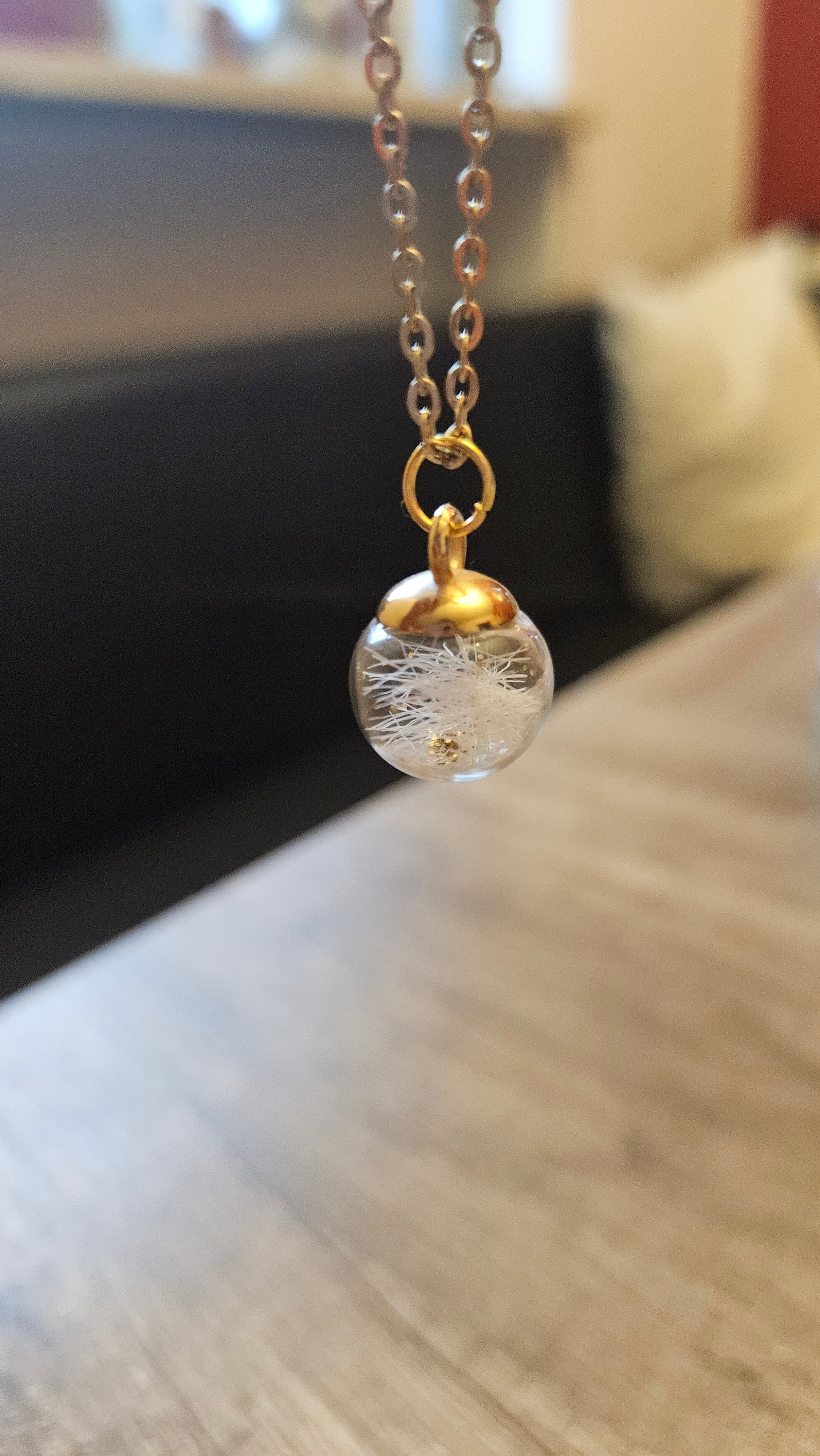 Glass bead filled with animal hair and chain