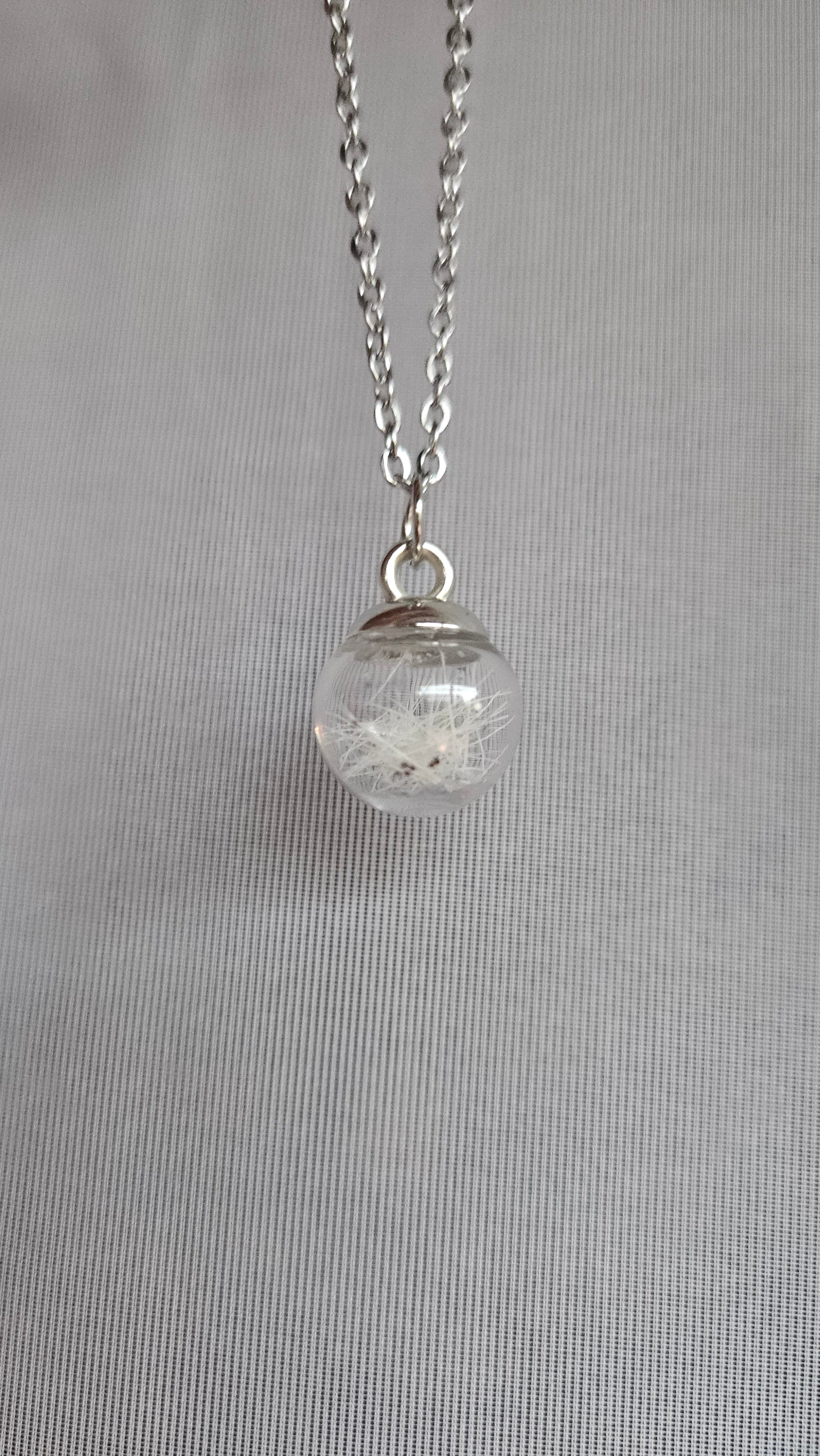 Glass bead filled with animal hair and chain